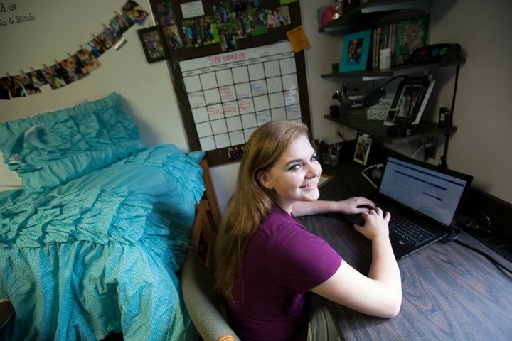 student working on laptop in Crandall Hall dorm room