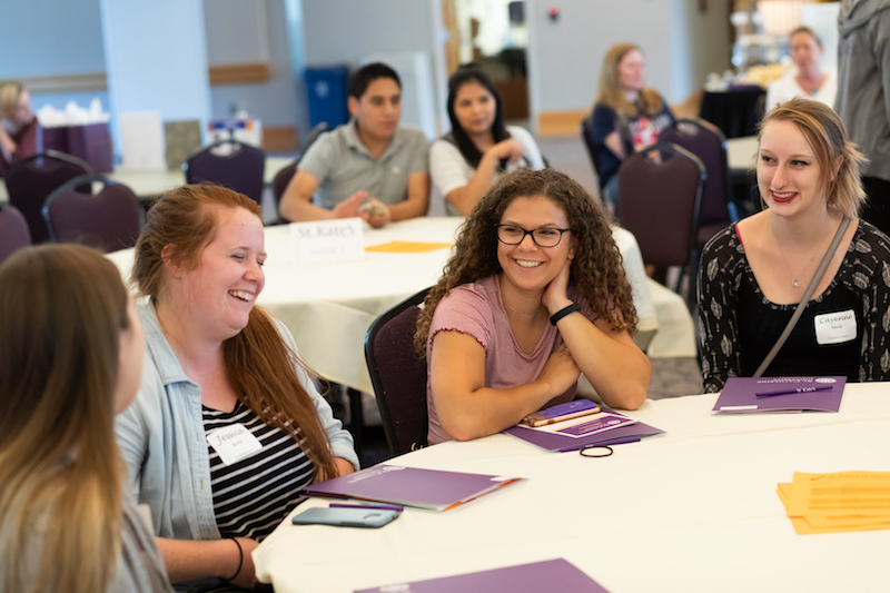 Students laugh and talk at St. Kate's orientation event for transfer students