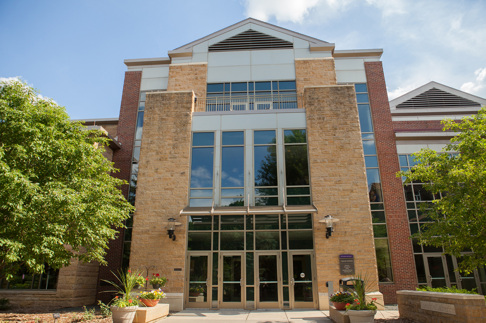 Photo of the Coeur de Catherine at St. Catherine University, a brick building with glass window entry