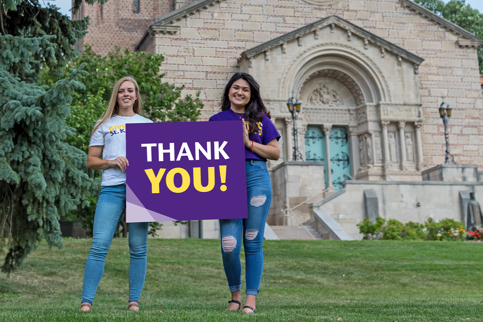 Two St. Kate's alumnae hold a sign that says Thank You