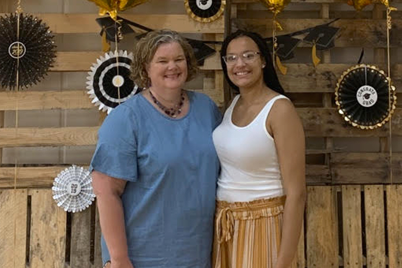 Liz (Campion) Francois ’86 and Mary Claire Francois '24, standing and smiling together.