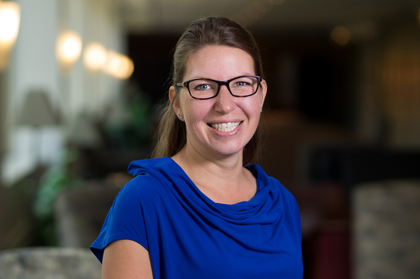 Wearing a blue shirt and glasses, Portrait of St. Catherine University Associate Professor of Nursing Renee Colsch, PhD, RN, SCRN, CQ