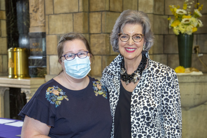 Staff member stands for recognition with President Roloff