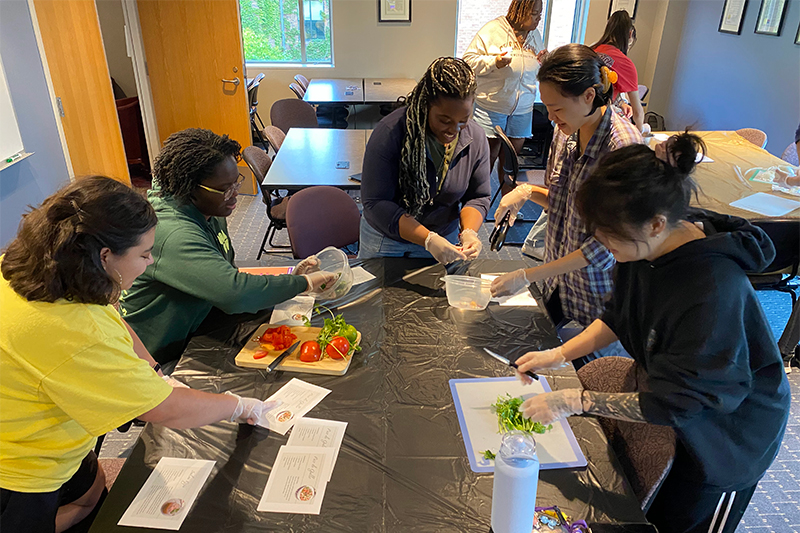 Students gathered around table making Salsa