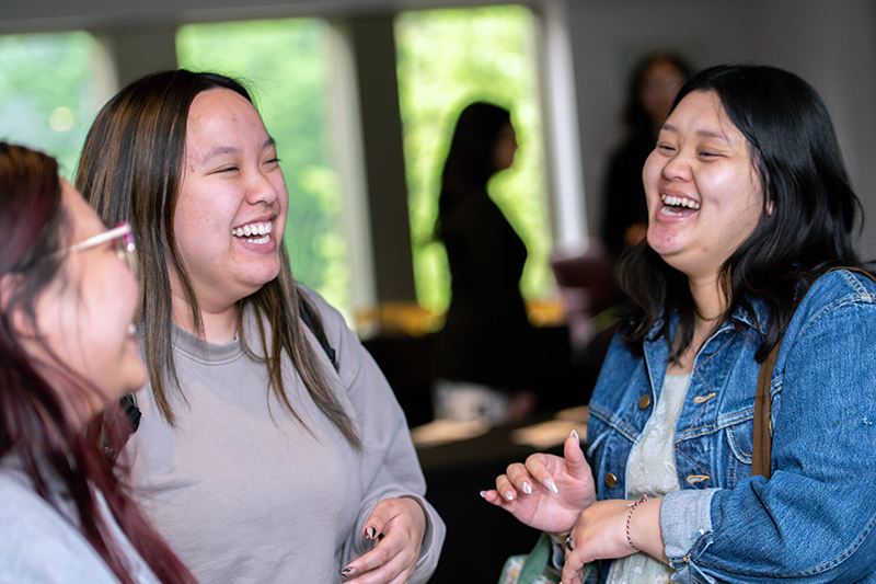 Three girls laughing together