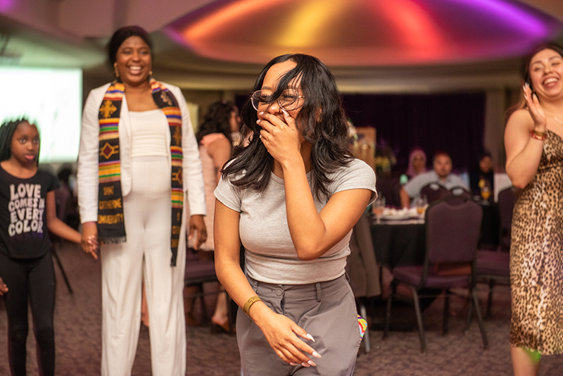 female student laughing and dancing at party