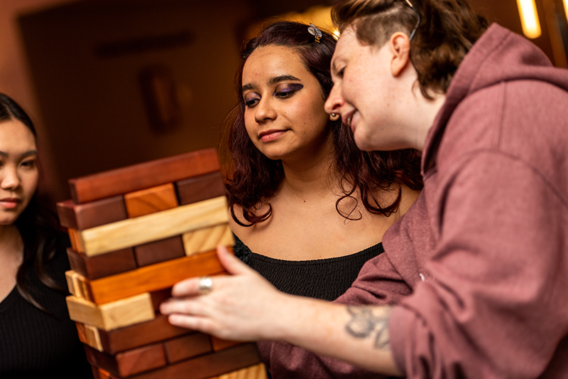 Two female students doing a giant Jenga game