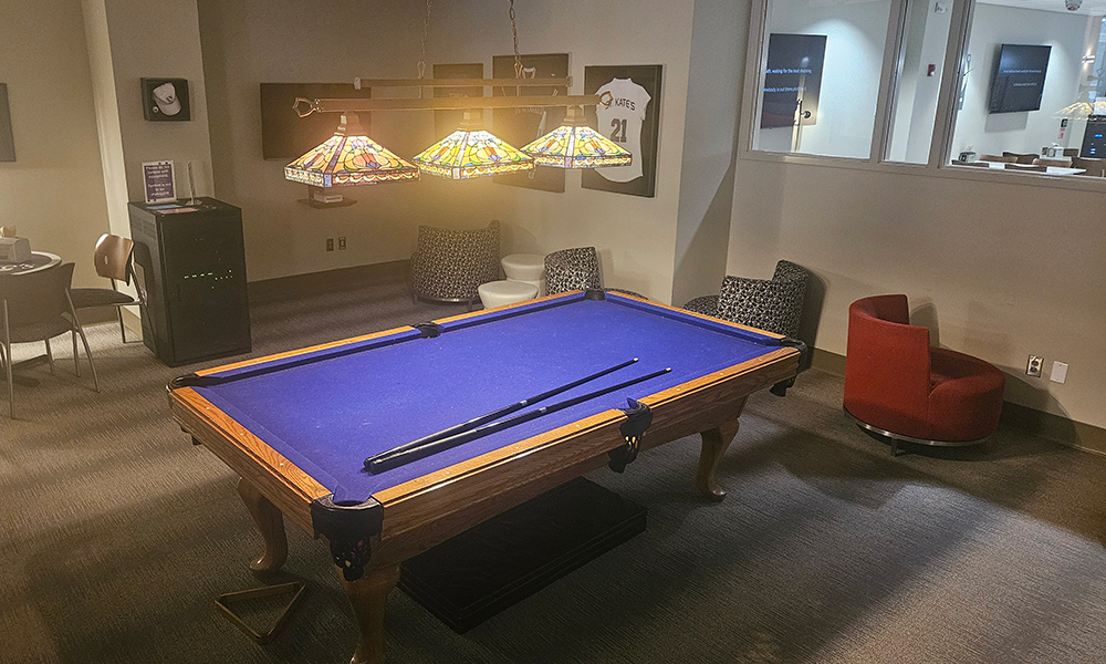 Picture of game room with pool table in the center