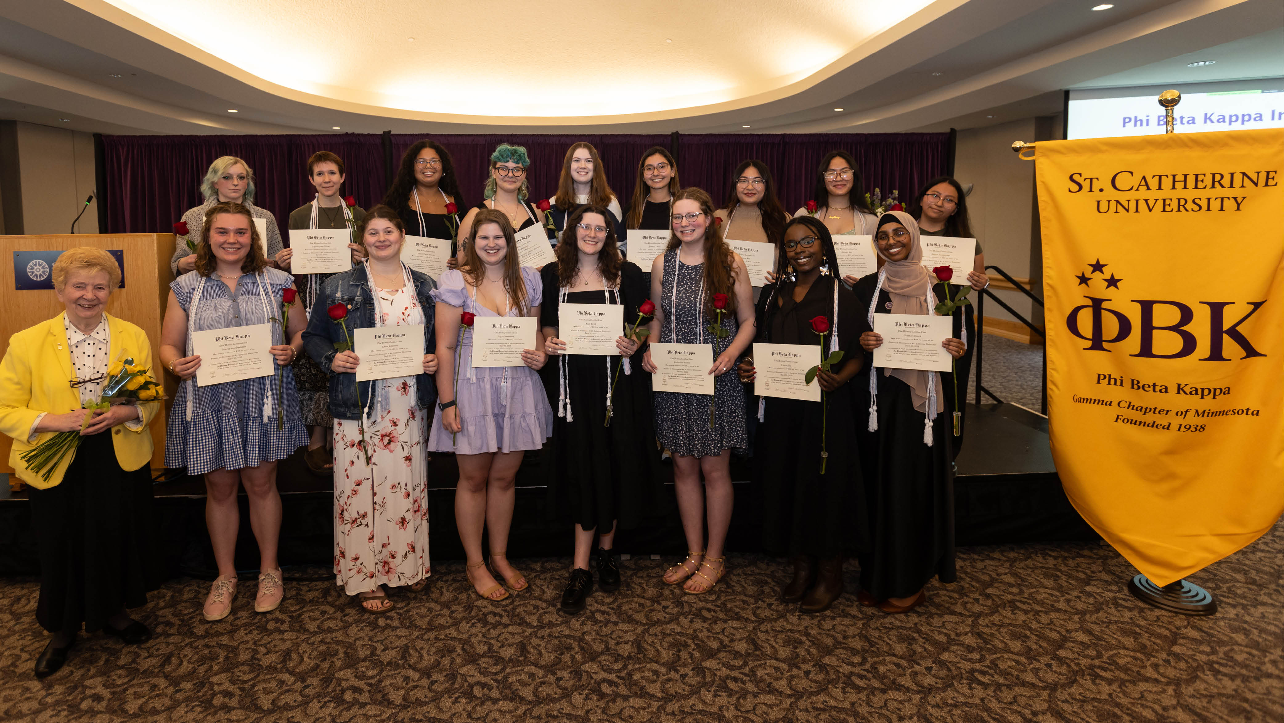 New inductees pose next to the Phi Beta Kappa banner. 