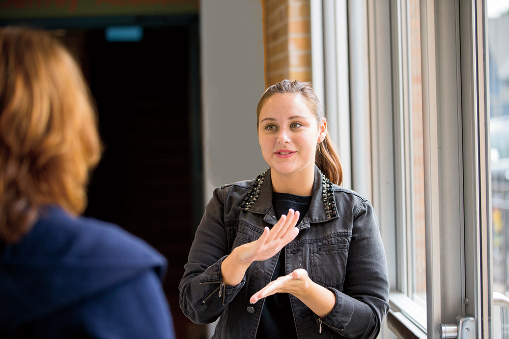 Woman signing to a deaf or hard-of-hearing individual