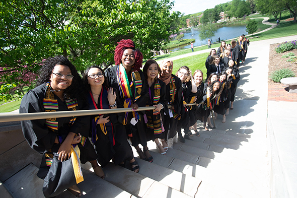 Graduates posing for picture on staircase outside