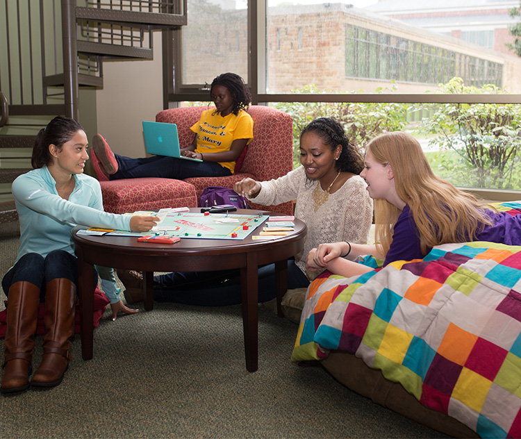 Three students hanging out in dorm