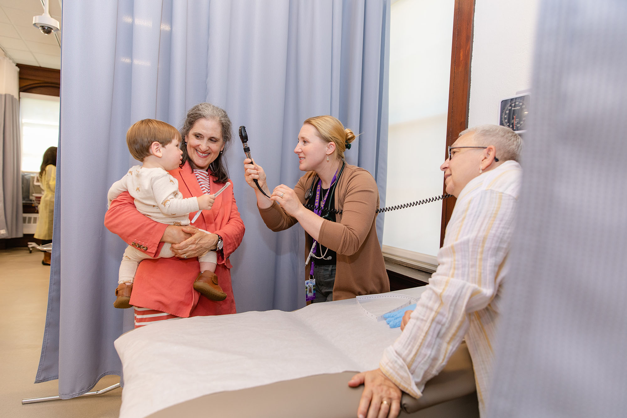Pediatric nurses working with mother and child
