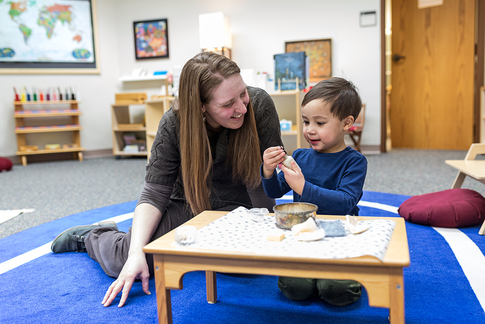 Montessori teacher working with student