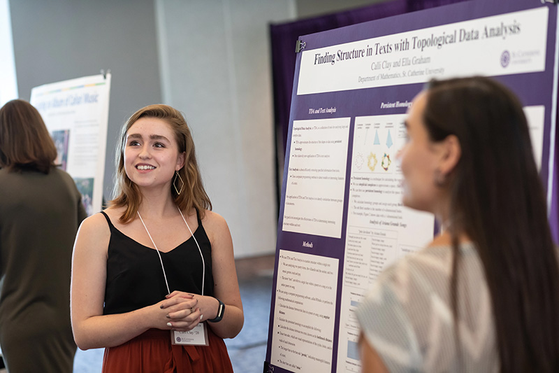 Women giving presentation in front of display