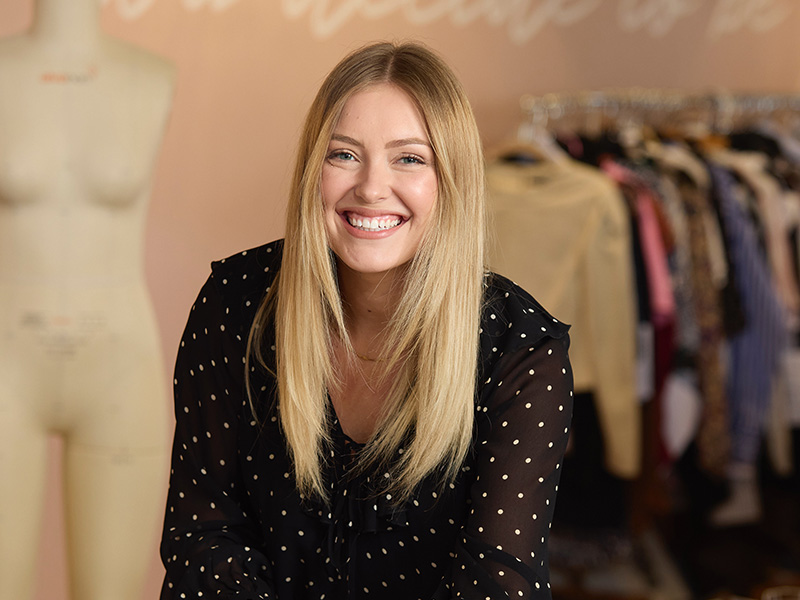 Fashion Design student posing for picture while working