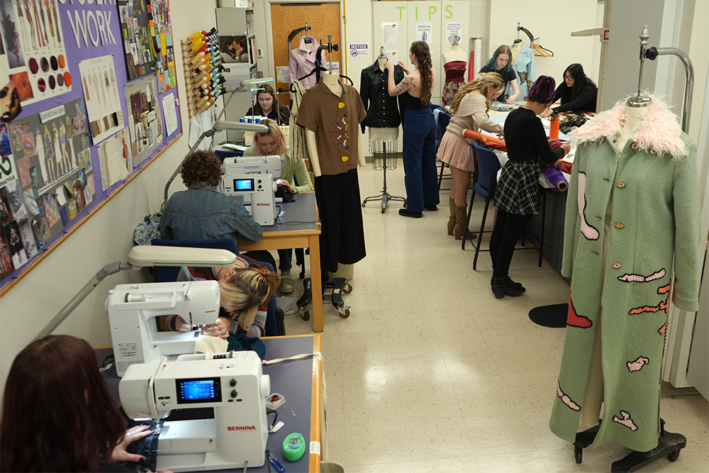 students working in fashion design studio classroom