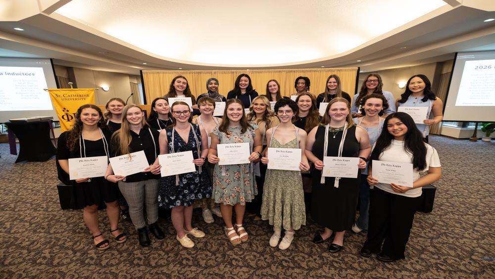 Phi Beta Kappa inductees pose with their certificates 