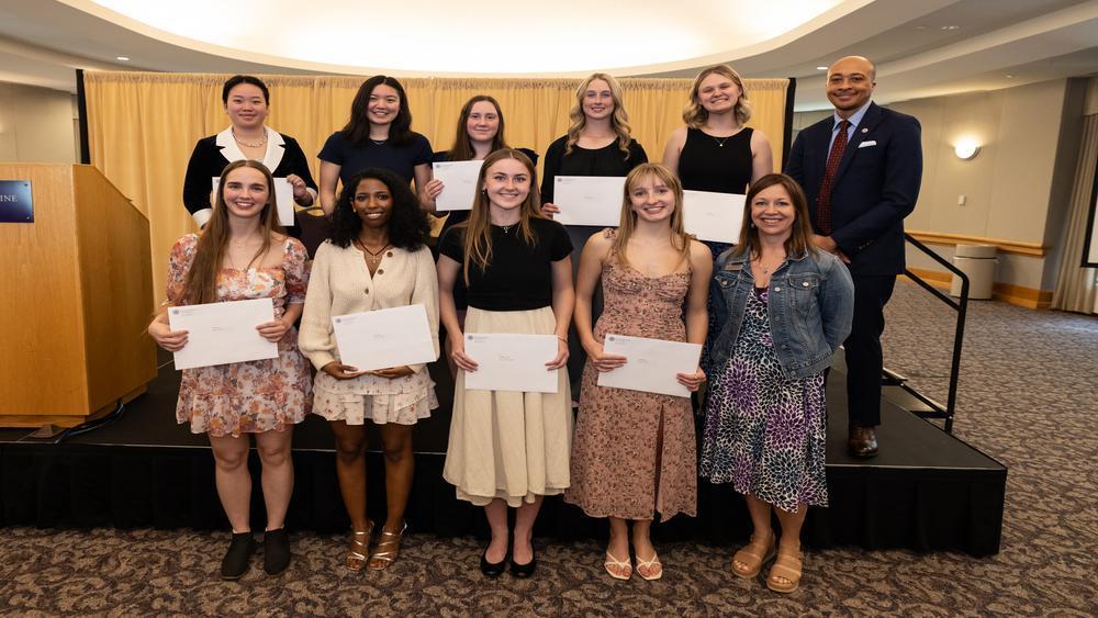 Students at the honors and awards ceremony pose with certificates.