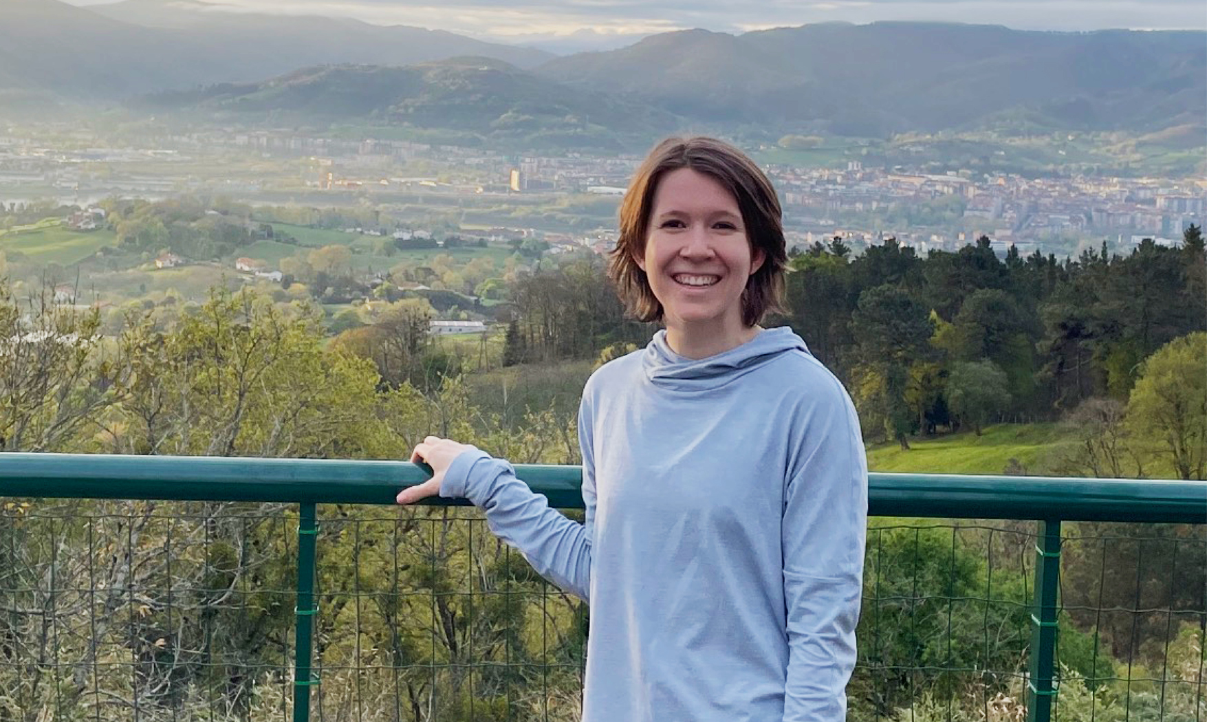 Theo von Weiss ’23 stands in front of a mountain range, wearing a gray hoodie