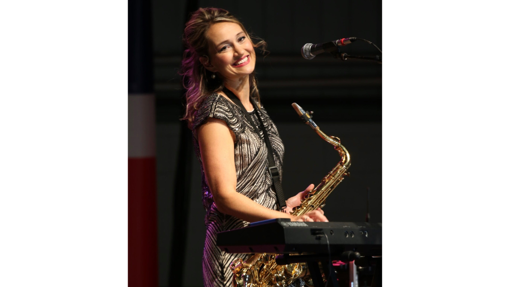Mollie B with a saxophone and at the keyboard