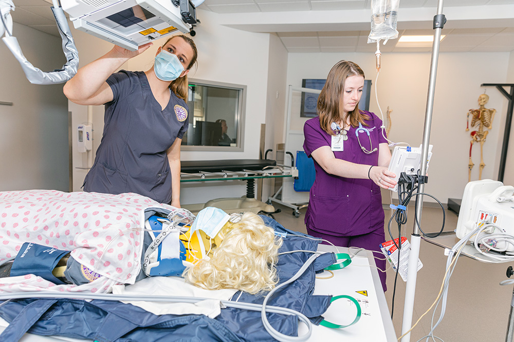 two nursing students performing simulation exercise