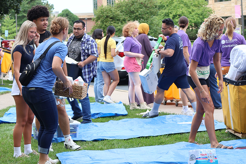 students outside preparing boxes to move into dorms