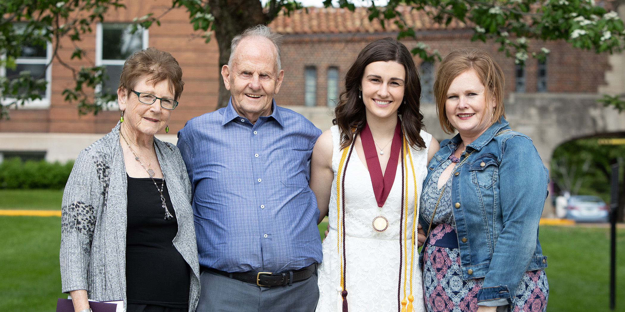 St. Kate's student stands with her family on campus