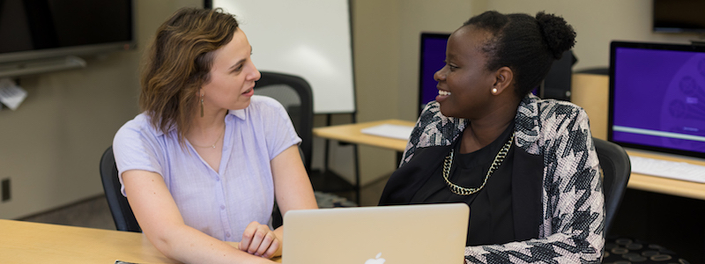 Two students in St. Kate's career services working together