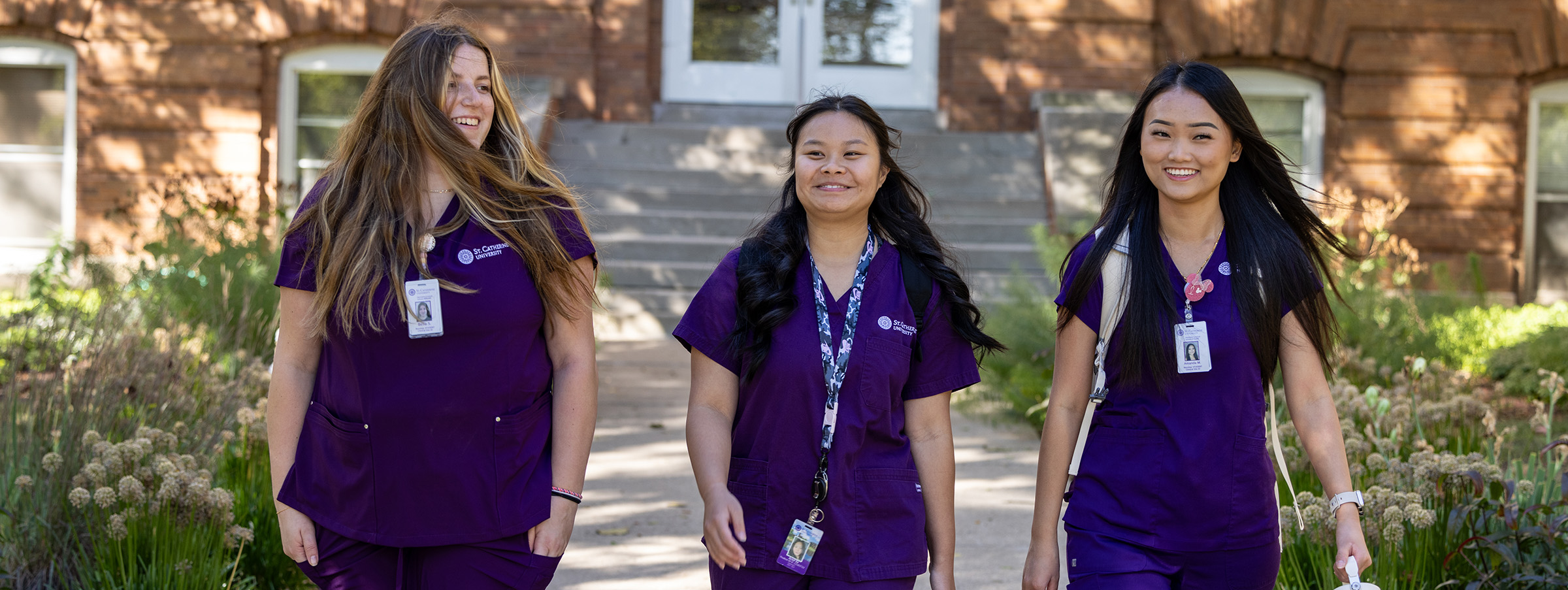 Three female nursing students walking together on campus
