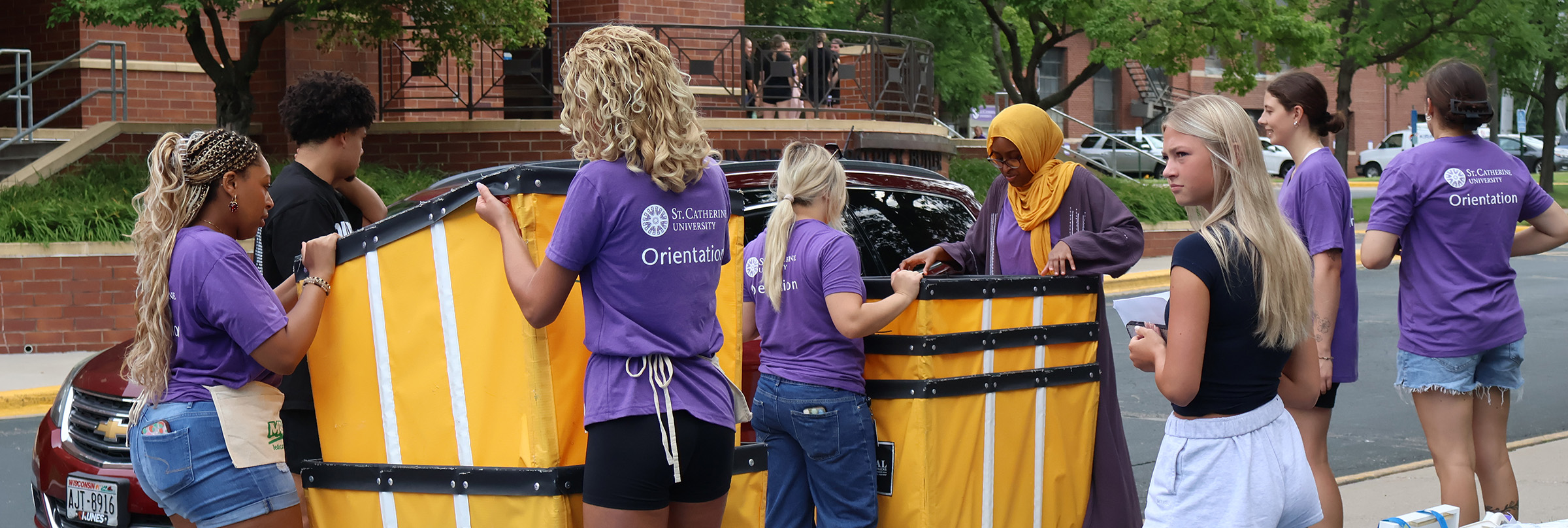 new students moving gear into housing