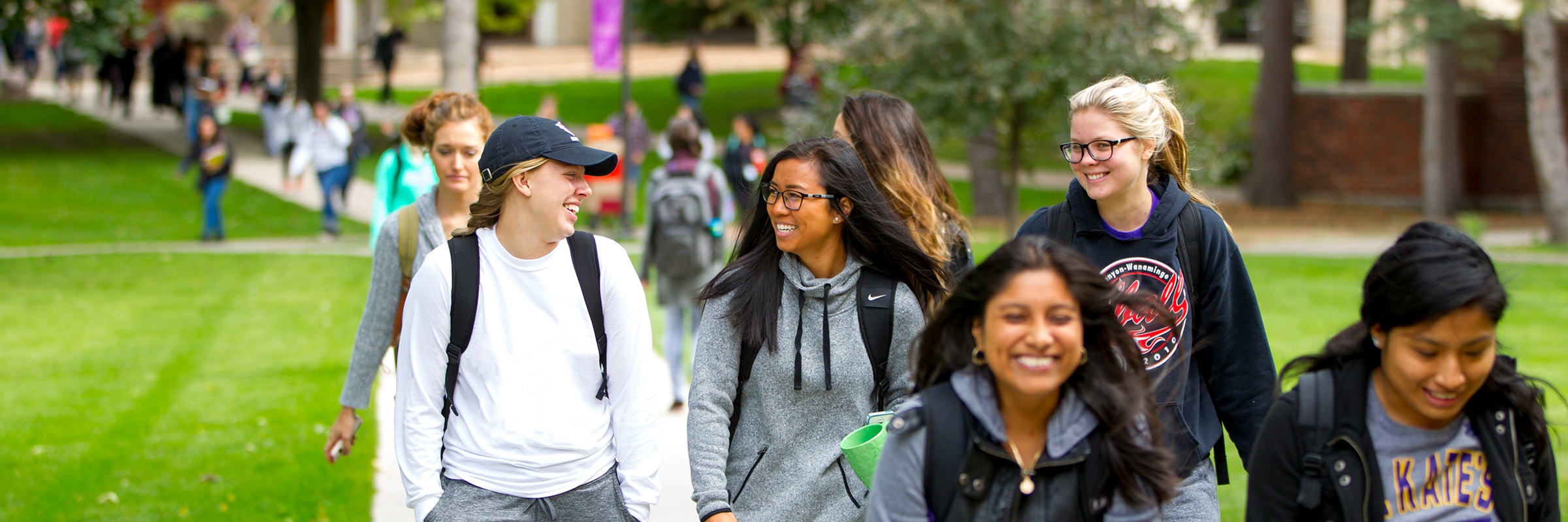photo of undergrad students walking and talking on campus