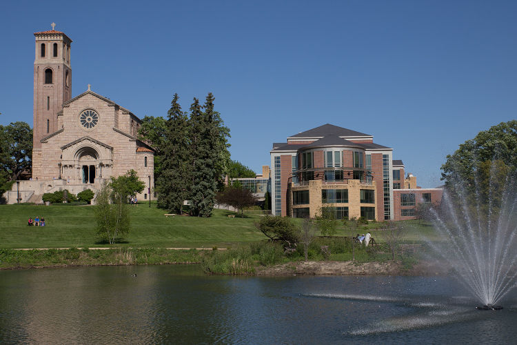 view of Our Lady of Victory Chapel and Coeur de Catherine from across the Dew Drop pond