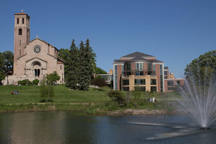 view of Our Lady of Victory Chapel and Coeur de Catherine from across the Dew Drop pond