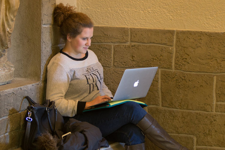Student working on computer in school building