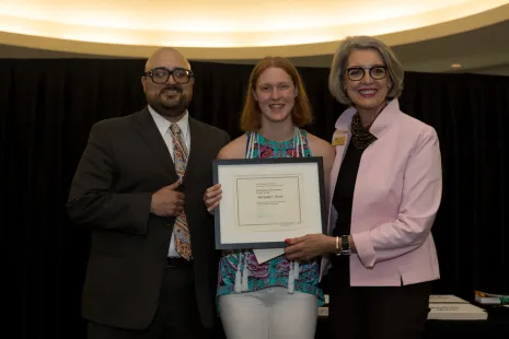 Michelle Perri (center) with professor Raphael Cervantes and President Roloff