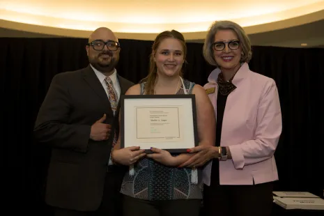 Shelby Auger with professor Raphael Cervantes and President Roloff
