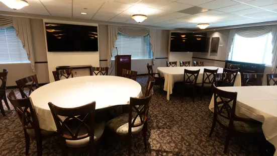 President's Dining Room from center, view of tables, tv screens and podium