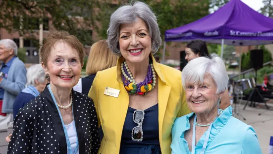 President ReBecca Koenig Roloff ’76 (center) poses for a photo with alumni at Reunion 2022.