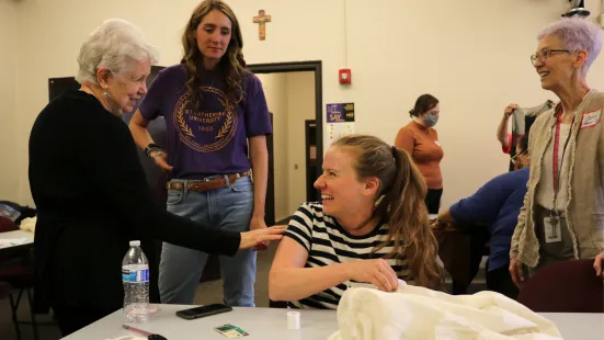 Volunteers laughing while working together 