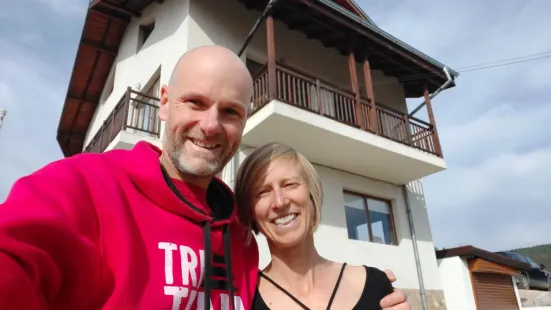 Jared Mitchell and Katie Eichten ’04 in front of their home