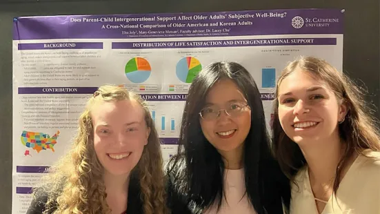 Student researchers with their presentation poster