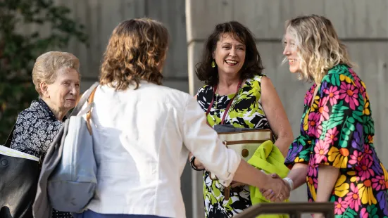 Alumni shake hands and greet one another at Reunion
