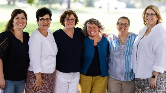 Alumni smile with their arms around one another at Reunion