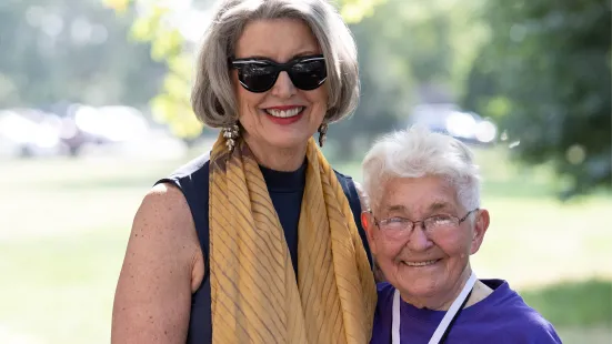 President Roloff '76 poses smiling with an alumna