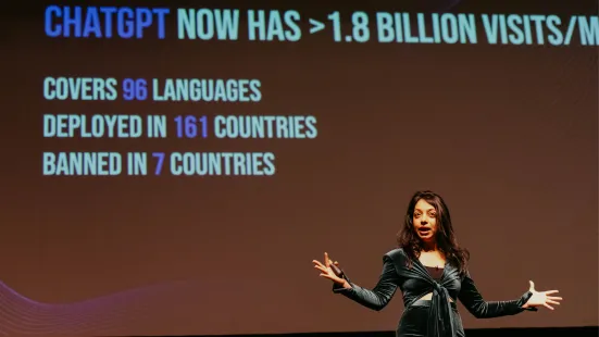 Radhika Dirks lectures in front of powerpoint presentation