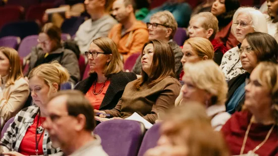 The audience in the O'Shaughnessy listens to the presentation. 