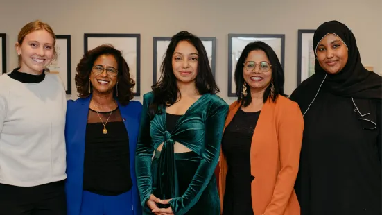 Radhika Dirks poses with Bindhu Alappat, PhD, and three panelists