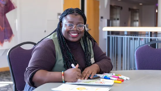 A woman coloring and smiling