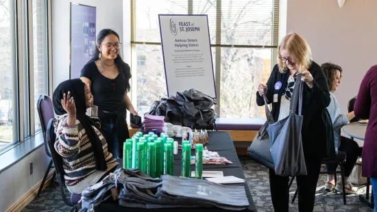 A group of people socializing at a service project table